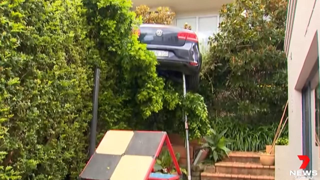 Mosman car accident: Woman hits neighbours fence, dangles 4m in air ...