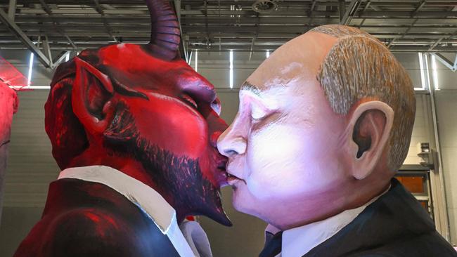 Putin – kissing the devil as a carnival float character in Cologne in February – needs to ‘be buried beyond any hope of recovery’. Picture: AFP