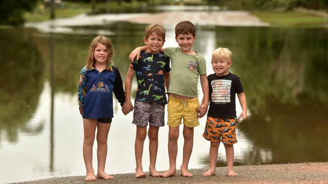 Tuesday February 4. Heavy rain causes flooding in North Queensland. Emme Widdecke, 4, Declan Turnball, 6, Parker Widdecke, 6, and Elliott Turnball, 3, at Mill Drive, Giru. Picture: Evan Morgan