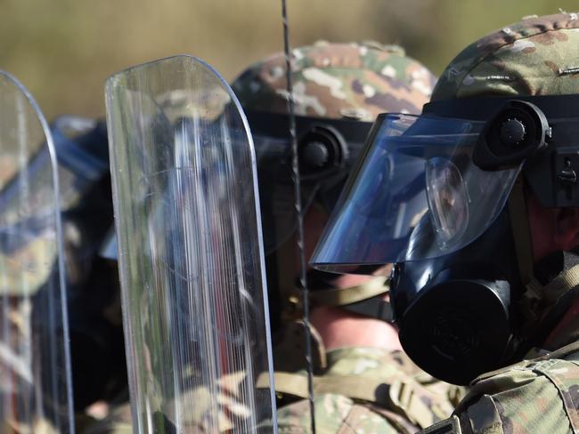 Police and military personnel face off against protesters. Picture: AFP