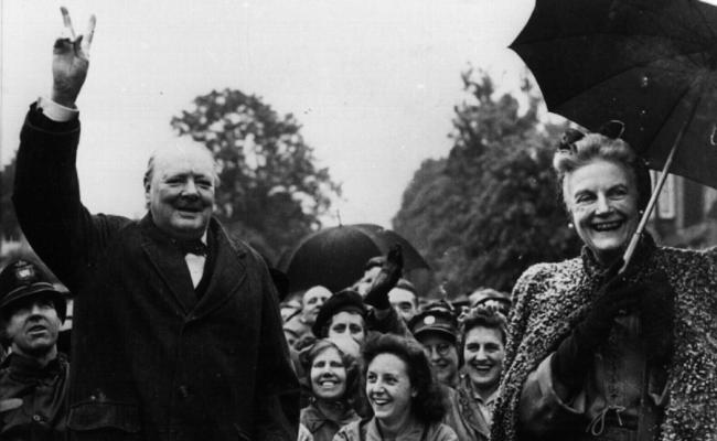 Britian's prime minister Winston Churchill, with wife Clementine, gives trademark "V" sign at end during World War II.