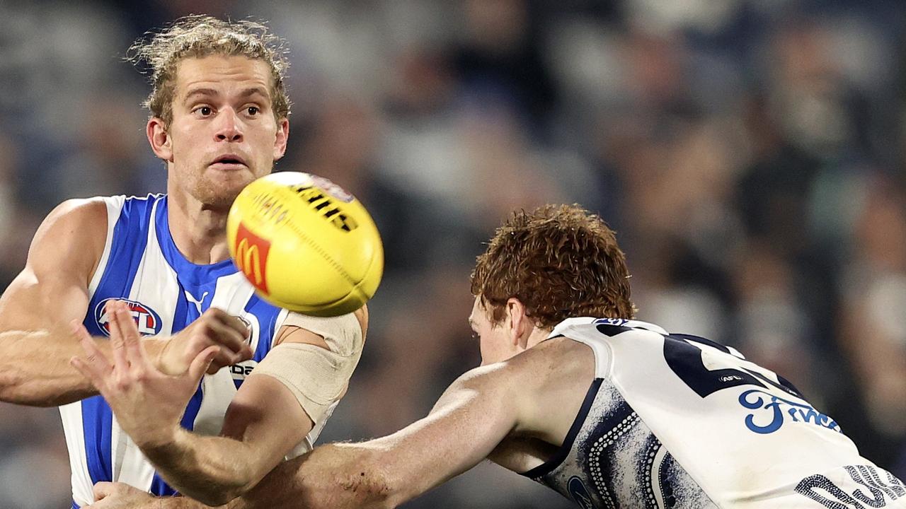 GEELONG, AUSTRALIA - JULY 02: Jed Anderson of the Kangaroos handballs during the round 16 AFL match between the Geelong Cats and the North Melbourne Kangaroos at GMHBA Stadium on July 02, 2022 in Geelong, Australia. (Photo by Martin Keep/AFL Photos via Getty Images)
