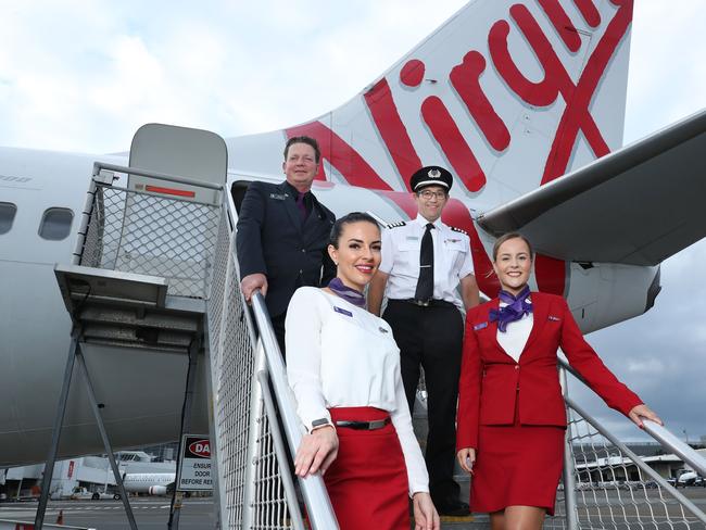 10/3/21: L to R..Nico Porter(CS), Bianca Yates, Captain Paul Anderson and Delia Taylor at Sydney airport. Virgin Australia crew are set to benefit from a suite of assistance measures being rolled out by the federal government to help airlines and the tourism industry continue to recover. John Feder/The Australian.