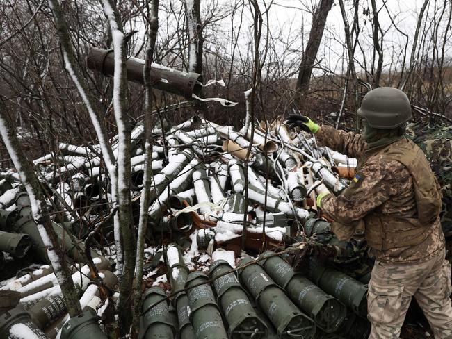 A Ukrainian artilleryman throws an empty 155MM shell tube as Ukrainian soldiers fire a M777 howitzer towards Russian positions on the frontline of eastern Ukraine, on November 23, 2022. Picture: Anatolii Stepanov/AFP