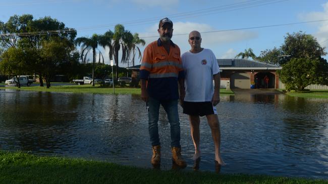 Ballina residents Nigel Keep and Garry Scott in Fox Street, which has been inundated with water as residents of some low-lying areas in the Ballina area evacuate on Tuesday morning. Picture: Liana Boss