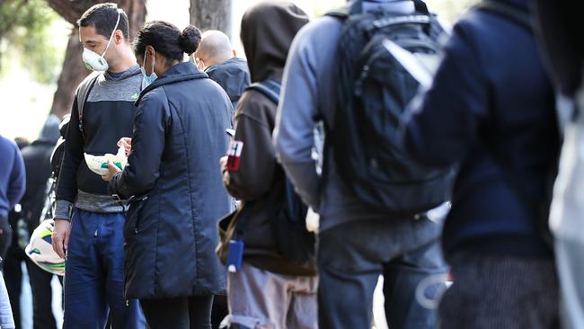 The labour surplus will fall sharply as we ride through the mini-spending boom leading up to Christmas; critically in the absence of foreign workers. Above, A line of people outside a Centrelink branch in Sydney last July during a system crash. Picture: Jane Dempster/The Australian.