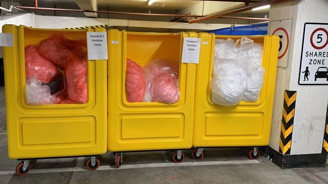 Bins containing linen from the Novotel/Ibis quarantine hotel stored in a residential carpark. Source: Supplied