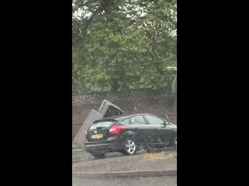 Dopey driver tries to carry sofa on top of car
