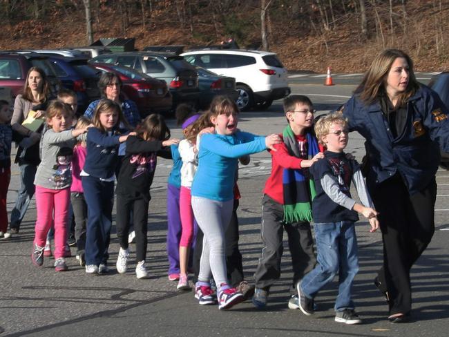 Connecticut State Police led a line of children from the Sandy Hook Elementary School in Newtown, Connecticut on December 14, 2012. Picture: AP