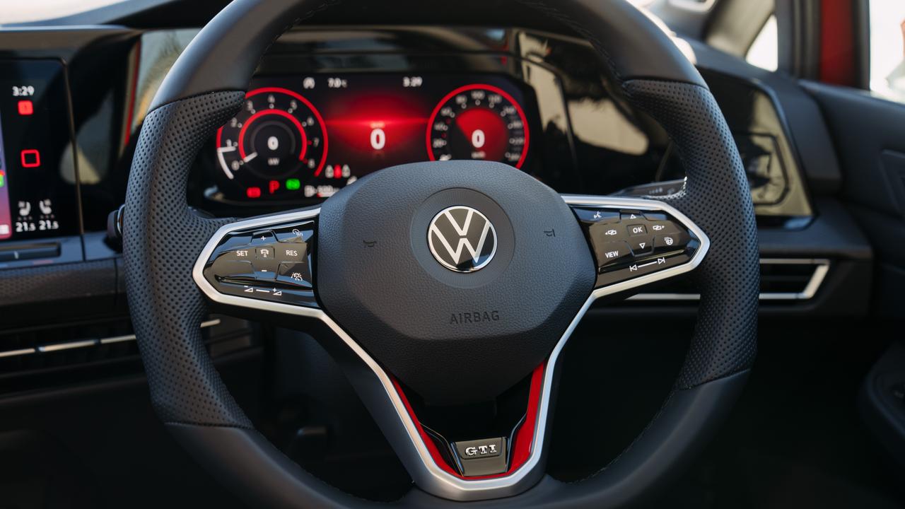 The new GTI has a near-buttonless cabin with glossy capacitive-touch controls.