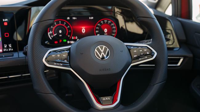 The new GTI has a near-buttonless cabin with glossy capacitive-touch controls.