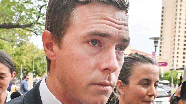 ADELAIDE, AUSTRALIA - NewsWire Photos, MARCH 13, 2024:  Cyclist Rohan Dennis, centre, leaves the Adelaide Magistrates Court where he is facing charges over the death of his wife Melissa Hoskins. Picture: NCA NewsWire / Brenton Edwards