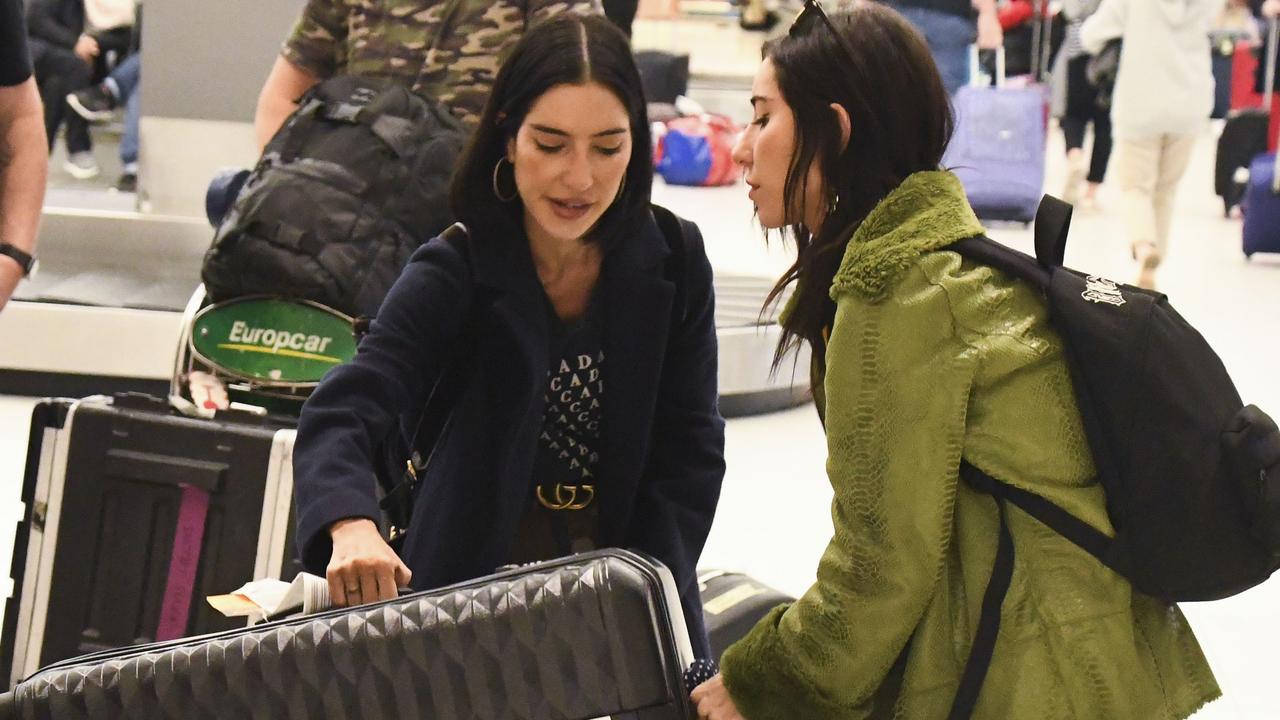 The sisters reached for their own luggage on the carousel belt at Sydney Airport. Picture: Media-mode.com