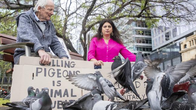 Keith "Jim" Fellingham and Samira Fateh in Victoria Square with signs protesting against pigeon culling in 2020. Picture: Simon Cross