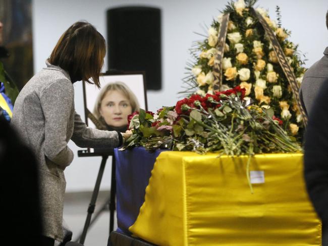 A woman lays flowers in tribute to a flight crew member of the Ukrainian 737-800 plane shot down by Iran. Picture: AP