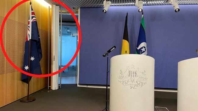 A staff member of Mr Bandt's removed the Australian flag from behind the lectern ahead of a press conference on Monday.