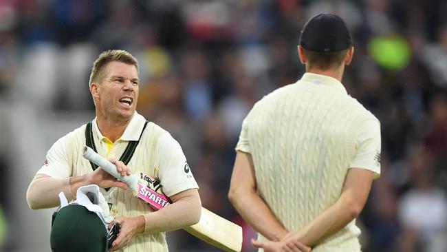 LEEDS, ENGLAND - AUGUST 22: Australia batsman David Warner has a word with England bowler Chris Woakes as players go off for bad light during day one of the 3rd Ashes Test match between England and Australia at Headingley on August 22, 2019 in Leeds, England. (Photo by Stu Forster/Getty Images)