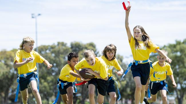 Archie Ferris goes for a touch down as Paige Schroeder gets his ribbon also chased by Coby Watson, Ky Morata, Charlie Castro-Winner and Hayden Ashfield at Kidman Park Primary School. Picture: Mark Brake