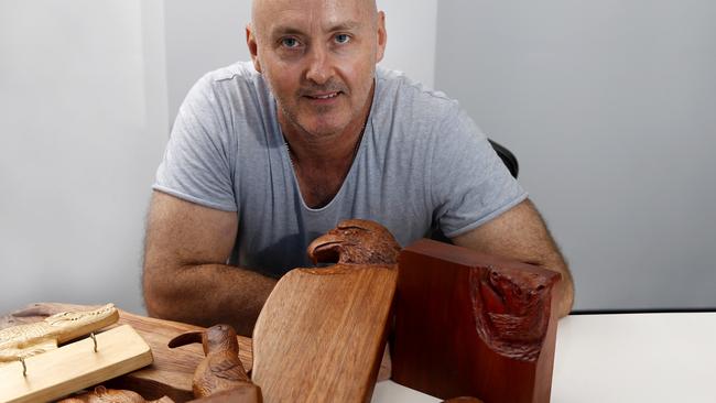 Woodcarver/chef Jay Powell with his unique animal styled cutting boards at the Yungaburra markets Picture: Anna Rogers