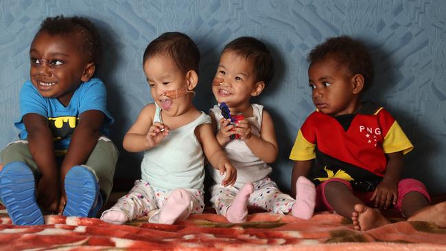 The girls sit with other kids at the retreat Jack Kalangis (left), Dawa, Nima and Annfredda Larry. Picture: Alex Coppel