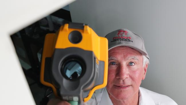 Pegasus Environmental Pest Control boss Murray Waugh checks a door architrave for termites with a thermal imaging camera. Picture: Glenn Hampson