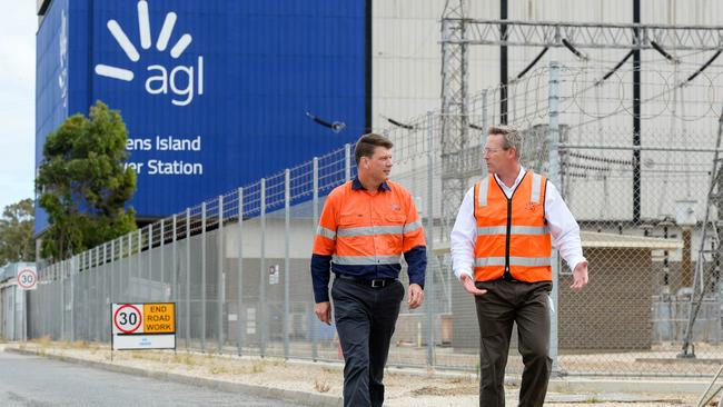 Brett Redman (left) with South Australian Energy Minister Dan Van Holst Pellekaan at AGL's Torrens Island Power Station, the site of the state's new biggest battery. Picture: Supplied by AGL