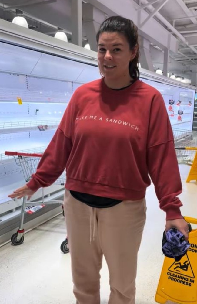 Local Meg Rawson stands among empty shelves. Picture: TikTok/Meg Rawson