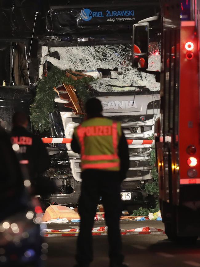 Police stand near a black lorry that ploughed through a Christmas market on December 19, 2016 in Berlin, Germany. At least nine people have died as police investigate the attack and whether it is linked to a terrorist plot. Picture: Getty