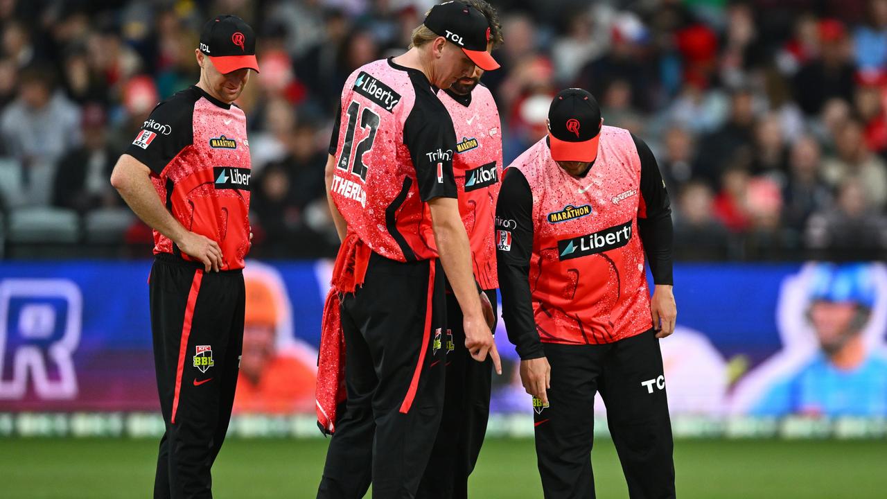 Melbourne Renegades players inspect the wicket during the December 10 match at GMHBA Stadium. Picture: Quinn Rooney/Getty Images.