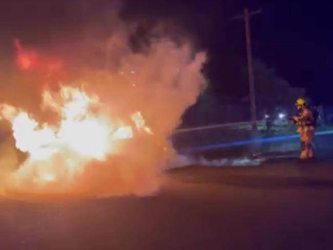 Fire and Rescue NSW extinguish a car on fire in Granville, believed to be linked to the execution-style murder of Tarek Ayoub.