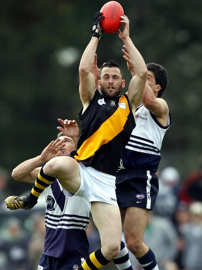 Heidelberg's Mark Favrin takes a mark. Picture: Andrew Brownbill