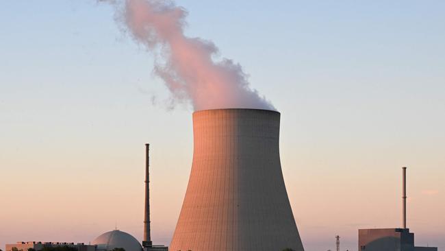 The Isar nuclear power plant with its cooling tower reflects in the river Isar in Essenbach, southern Germany, in 2022. Picture: Christof Stache/AFP