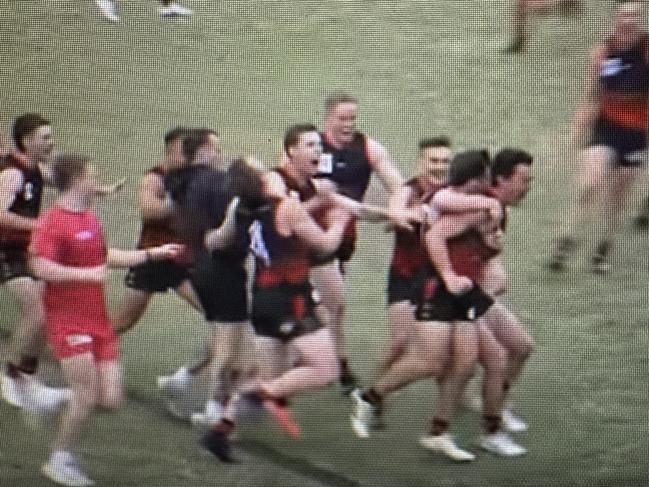 Aiden Gajanovic is mobbed by Emerald teammates after kicking the winning goal.