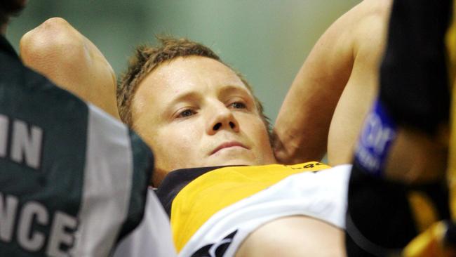 A stoic Nathan Brown is carried from the field after breaking his leg.