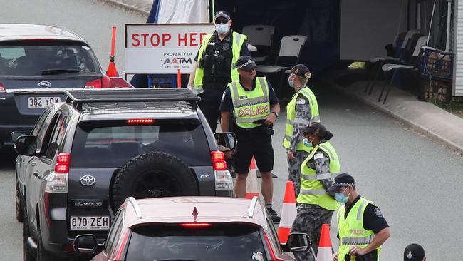 Police check the passes of people crossing the border in to Qld on the Pacific Highway at Coolangatta. Picture Glenn Hampson