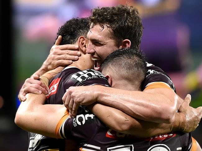 BRISBANE, AUSTRALIA - JULY 11: Xavier Coates of the Broncos celebrates with team mates after scoring a try during the round nine NRL match between the Brisbane Broncos and the Canterbury Bulldogs at Suncorp Stadium on July 11, 2020 in Brisbane, Australia. (Photo by Albert Perez/Getty Images)