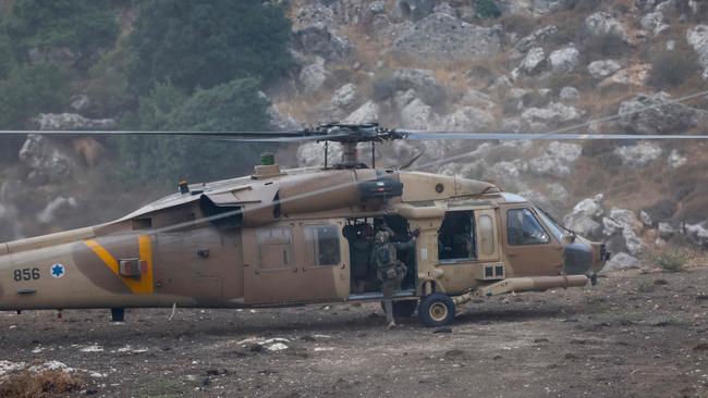 Israeli security forces leave in a helicopter near a site where a reported strike from Lebanon fell in Majdal Shams village in the Israeli-annexed Golan area. Picture: AFP