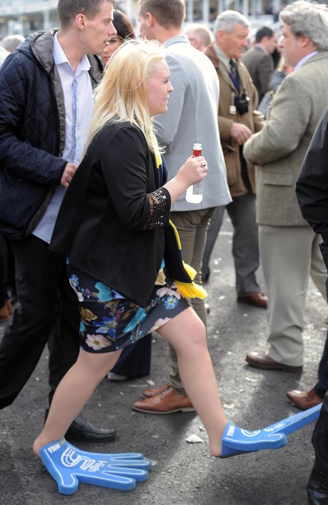 One woman took two foam hands from a race day worker in order to save her feet from pain. Picture: Mercury Press