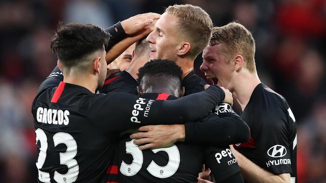 Mitchell Duke of the Western Sydney Wanderers celebrates scoring one of his two goals with teammates during the round-one A-League match won 2-1 against the Central Coast Mariners at Bankwest Stadium on Saturday. Picture: Getty Images