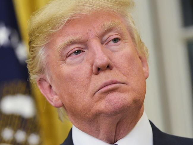 US President Donald Trump watches as Treasury Secretary Steven Mnuchin speaks after taking the oath of office in the Oval Office of the White House on February 13, 2017 in Washington, DC. / AFP PHOTO / MANDEL NGAN