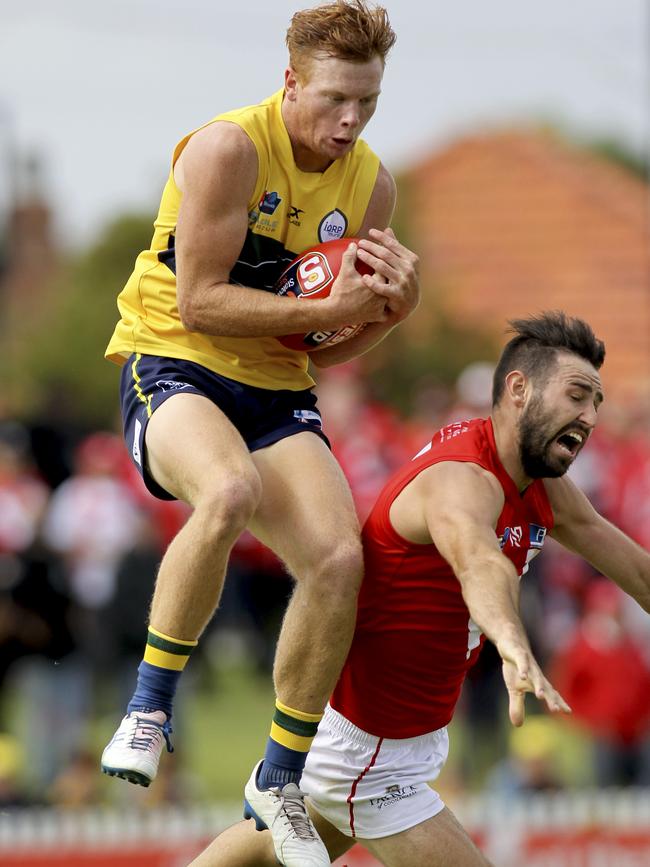 Young Eagle Jake Weidemann takes a strong mark over North's Tanner Smith. Picture: AAP Image/Dean Martin