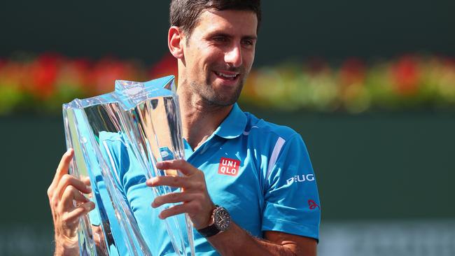 INDIAN WELLS, CA - MARCH 20: Novak Djokovic of Serbia holds up the winners trophy after his win over Milos Raonic of Canada during day fourteen of the BNP Paribas Open at Indian Wells Tennis Garden on March 20, 2016 in Indian Wells, California. Julian Finney/Getty Images/AFP == FOR NEWSPAPERS, INTERNET, TELCOS & TELEVISION USE ONLY ==