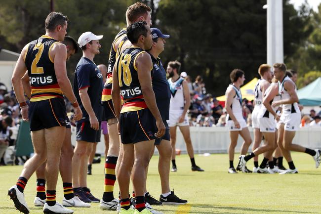 Crows and Port players wait on the boundary line for rotations due to extreme heat at Port Pirie. Picture SARAH REED