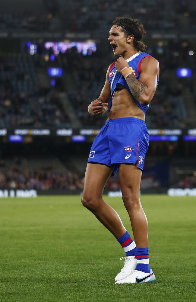 Jamarra Ugle-Hagan of the Bulldogs points to his skin as he celebrates kicking a goal