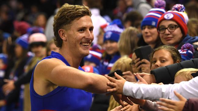 Aaron Naughton soaks up the praise of Western Bulldogs fans after the club’s win over Richmond. Picture: AAP Image/Julian Smith.