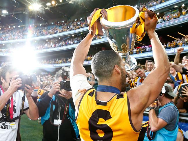 Hawthorn's Josh Gibson celebrates with the trophy after the 2014 AFL Grand Final match between Hawthorn Hawks and the Sydney Swans at the MCG Melbourne Cricket Ground on September 27, 2014. Picture: Wayne Ludbey