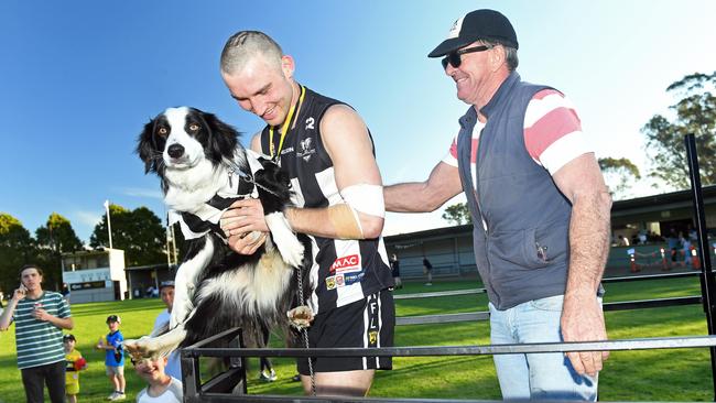 Hahndorf’s Troy Parker-Poers with his dog Jasper after his team beat Uraidla to win the Hills Div 1 grand final. Picture: Tom Huntley