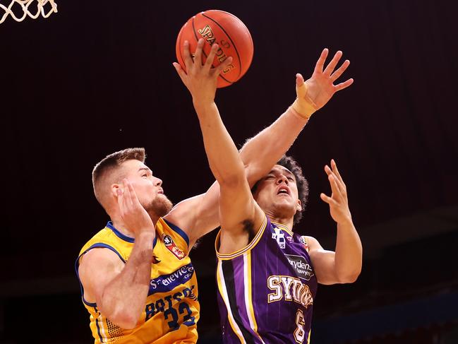 Jaylin Galloway of the Kings lays up a shot under pressure from Jack Salt of the Bullets during the round eight NBL match between Sydney Kings and Brisbane Bullets at Qudos Bank Arena on January 23, 2022, in Sydney. Picture: Mark Kolbe