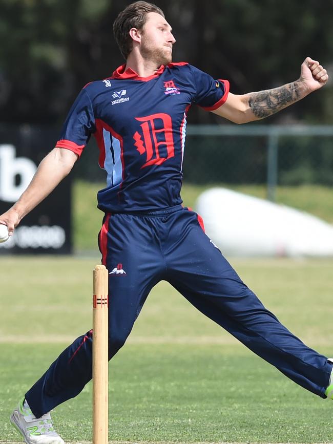 Adam McMaster bowling for Dandenong. Picture: AAP/Chris Eastman