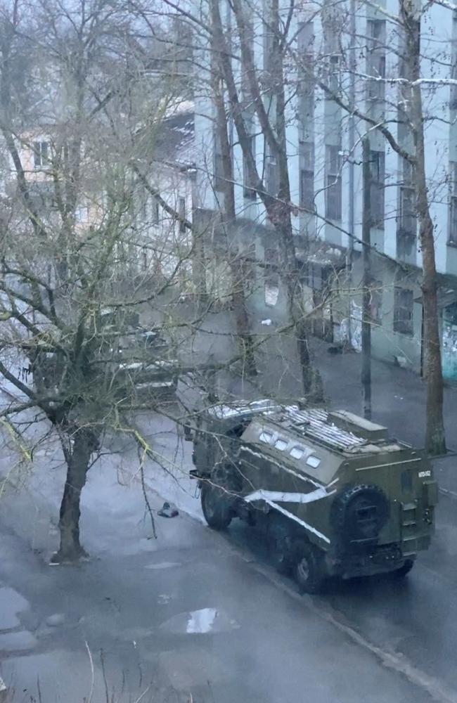 A military truck and tank are seen on a street of Kherson. Image: Reuters